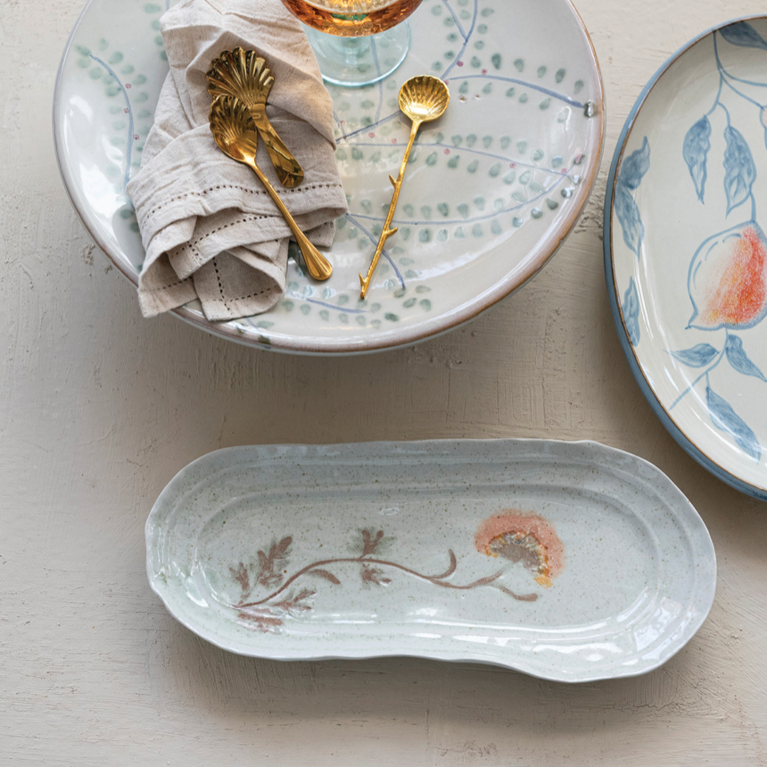 Ceramic plates with floral designs on a light surface