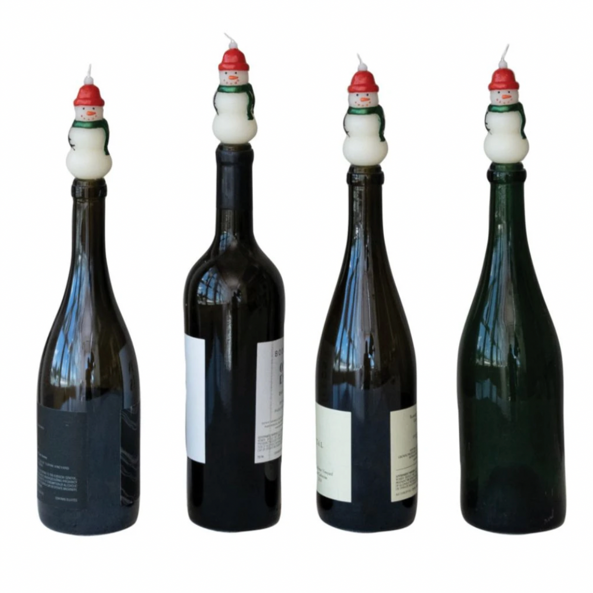 Four dark glass bottle candles with snowman-shaped wicks, shown from different angles on a plain white background.
