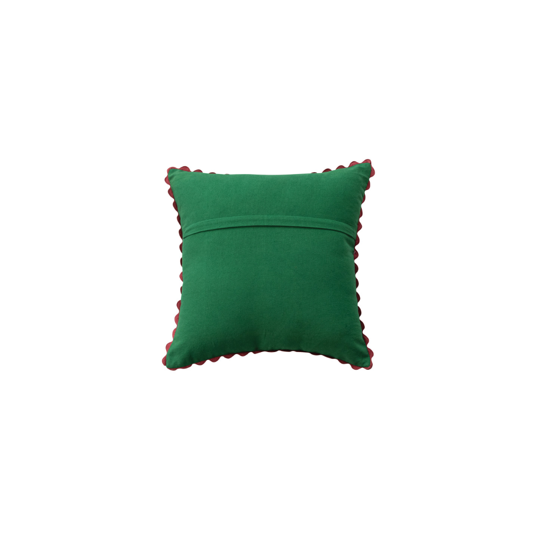 the back- A square green velvet throw pillow with a red scalloped edge trim, shown against a plain white background.