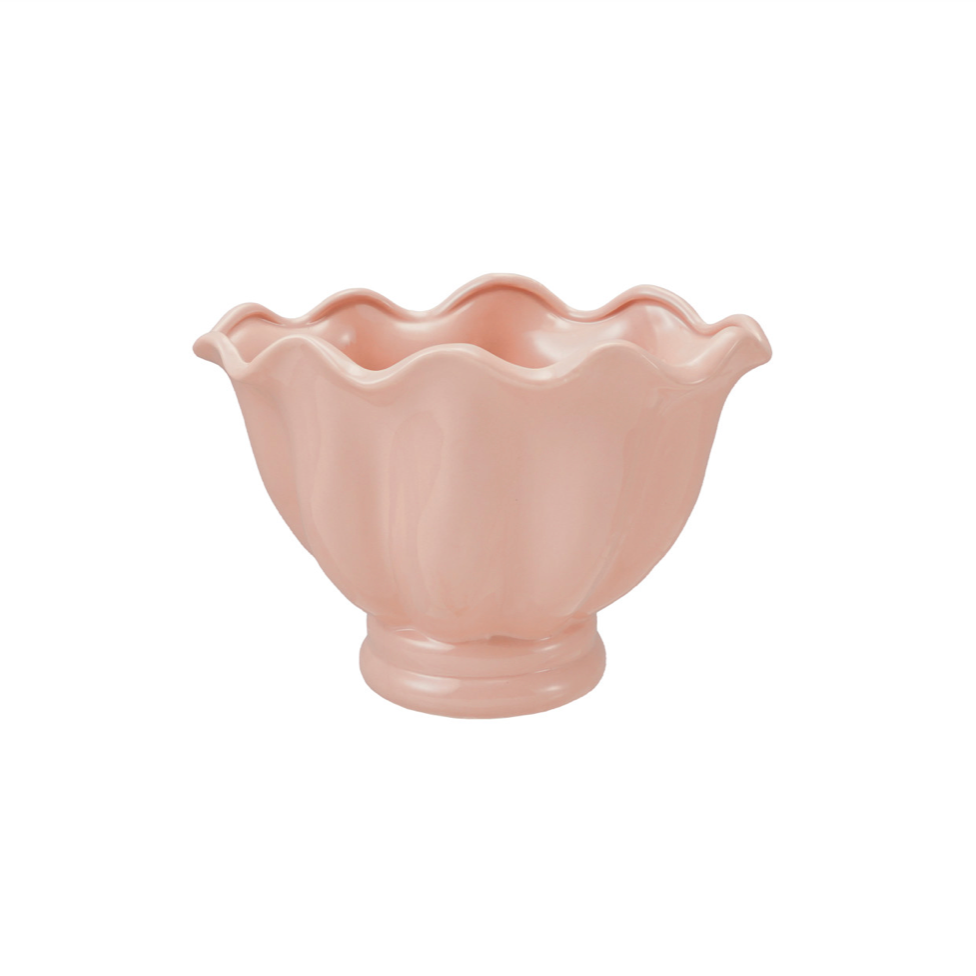 A small pastel pink ceramic bowl with a scalloped rim and a flared base, shown on a plain white background.