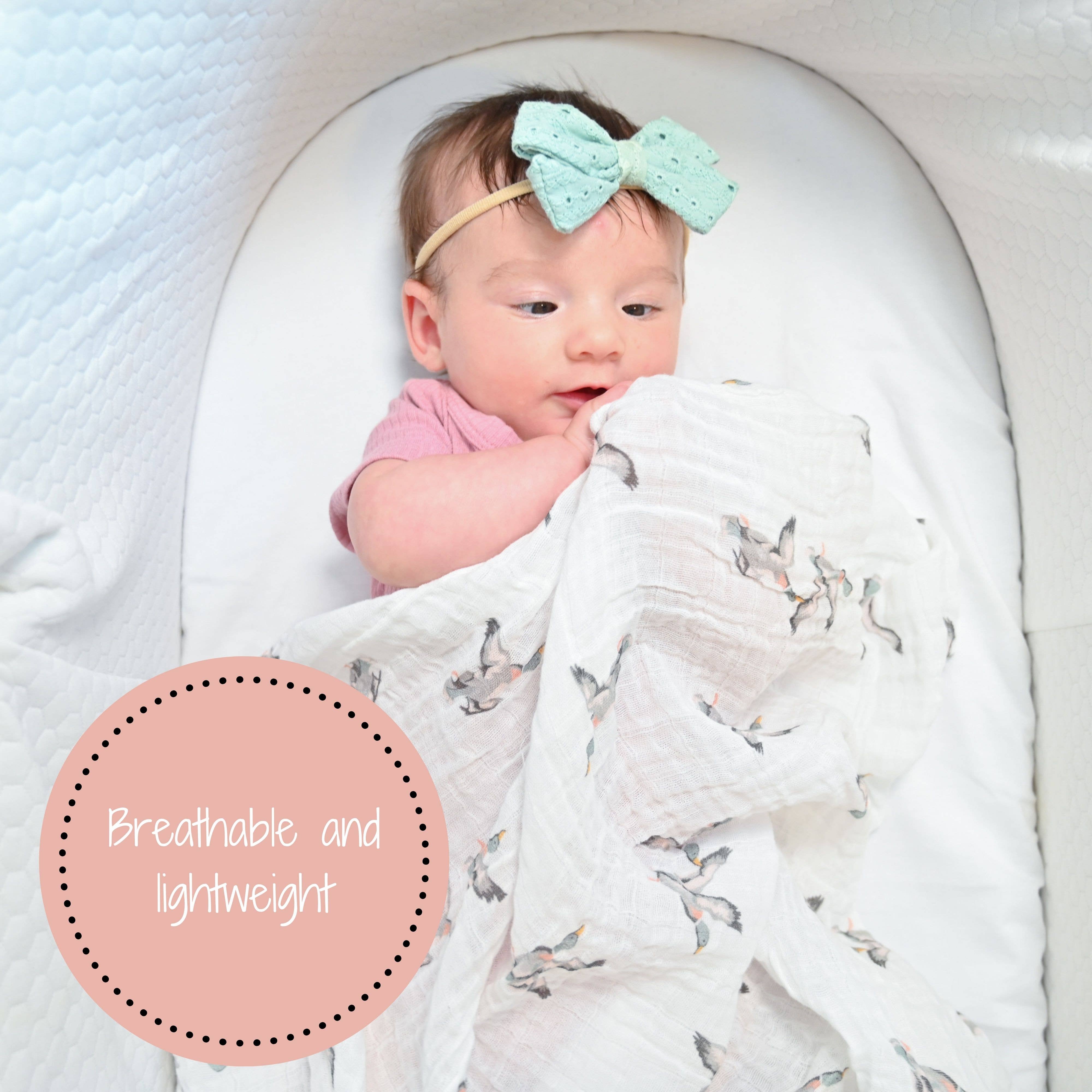 Baby wrapped in a blanket with a bow headband, text 'Breathable and lightweight' on a pink circle.