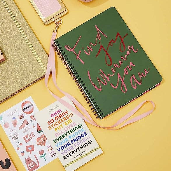 Notebook with 'Find Joy Wherever You Are' text on a yellow background
