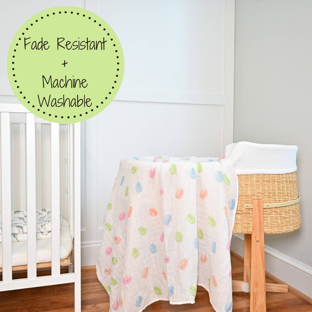 Baby blanket with colorful patterns draped over a crib in a nursery setting.