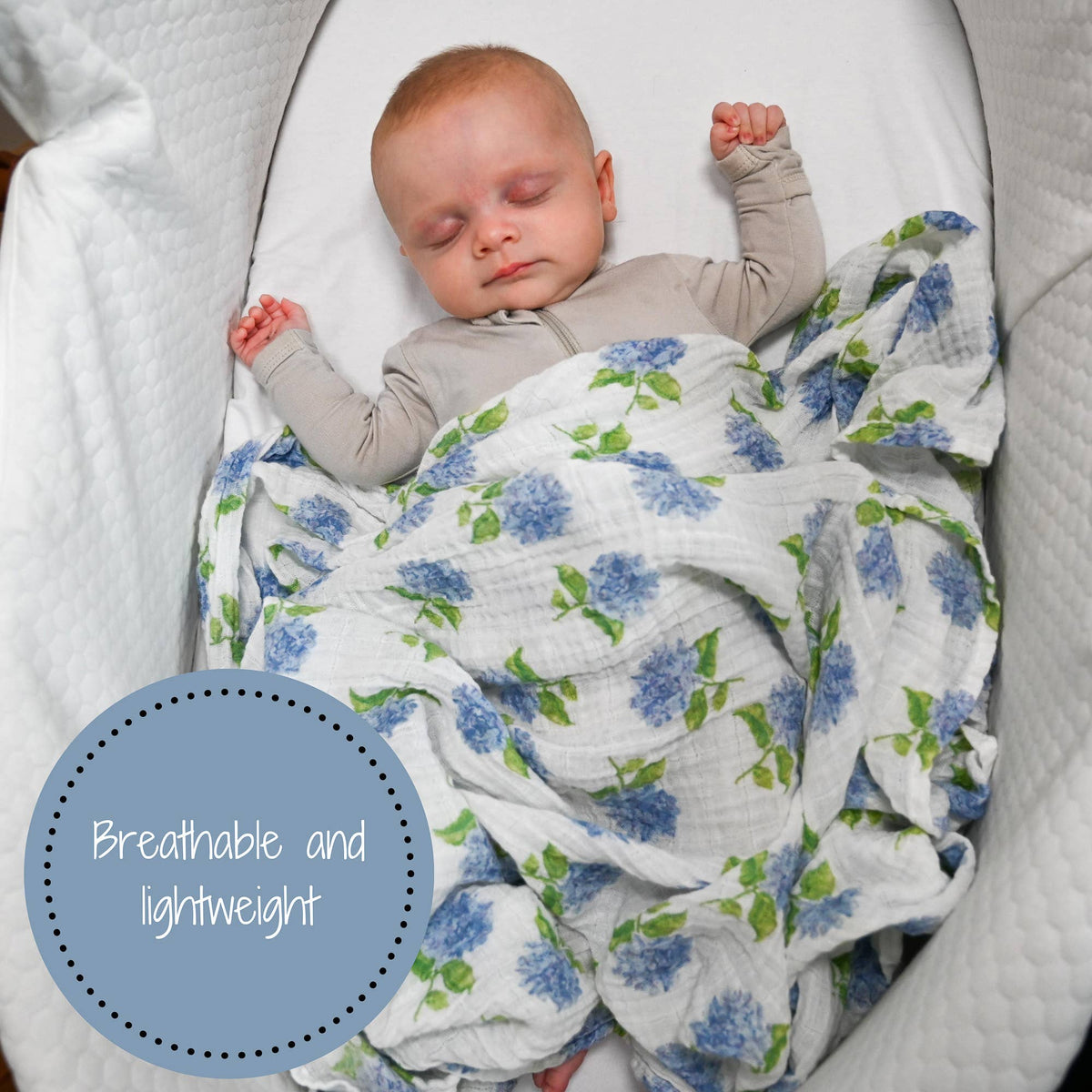 Newborn baby sleeping in a crib with a floral blanket, with text 'Breathable and lightweight' on a blue circle.