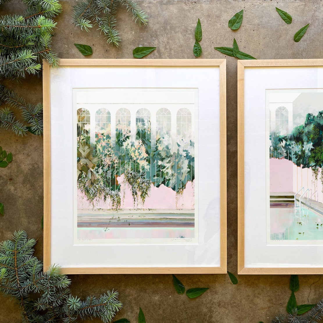 print shown in a frame against cement with leaves scattered around. 