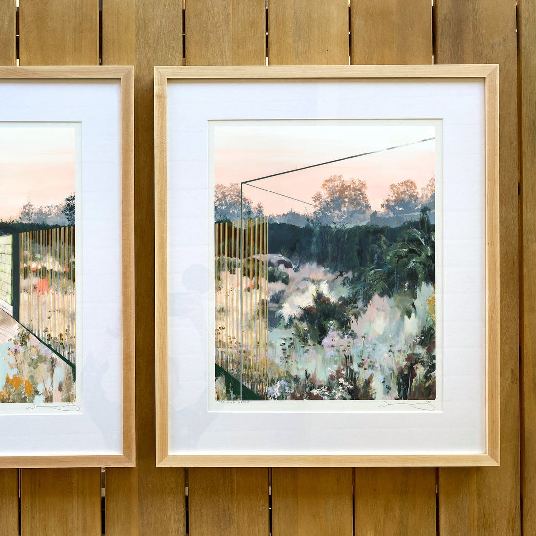 print shown in frame against wooden table.