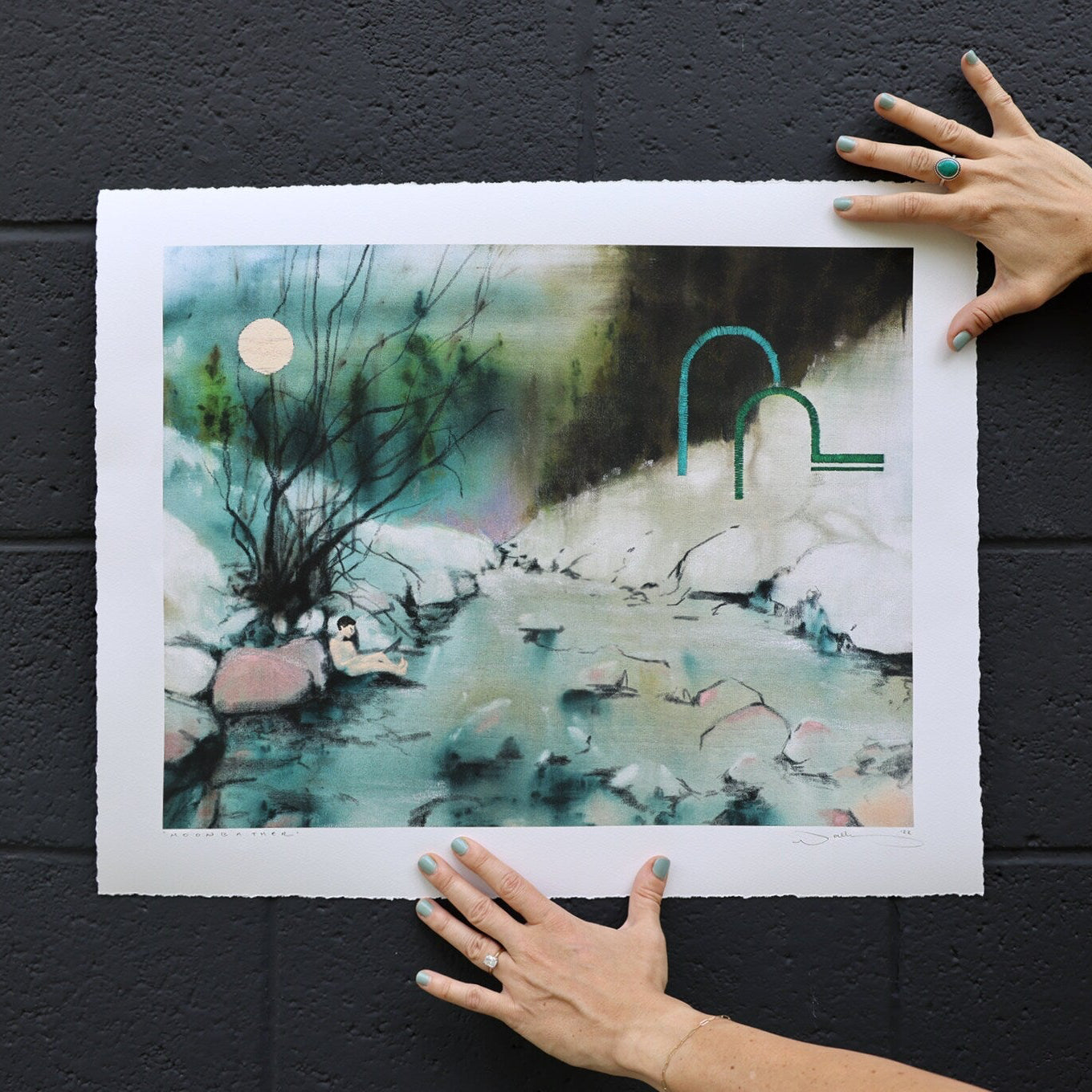 print shown against black brick. 