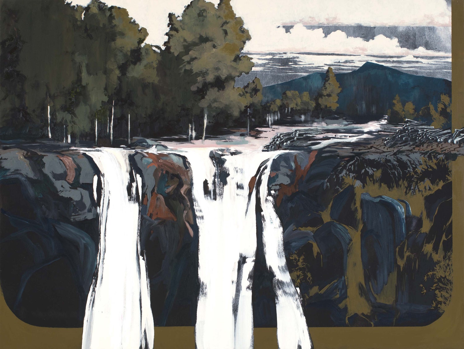 stark white waterfalls crashing down over bark blue and grey rocks with olive green trees in the background. 