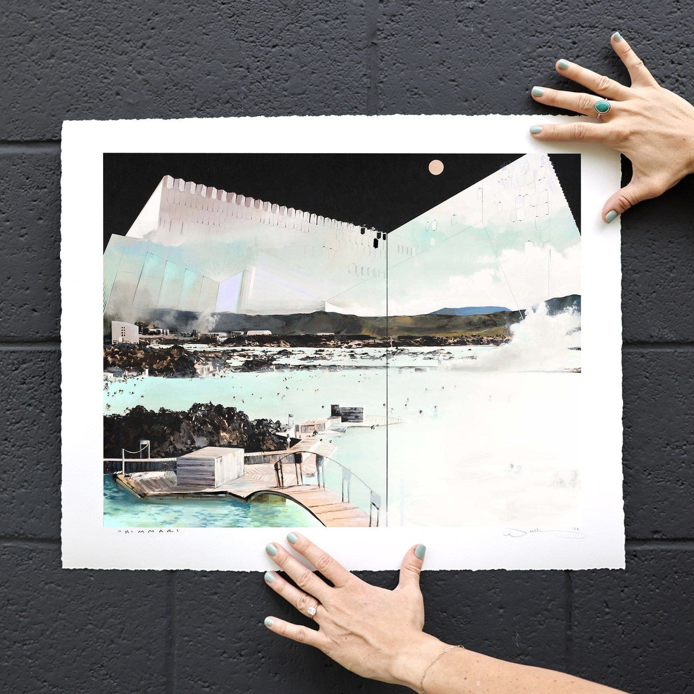 print shown on black bricks held in place by hands. 