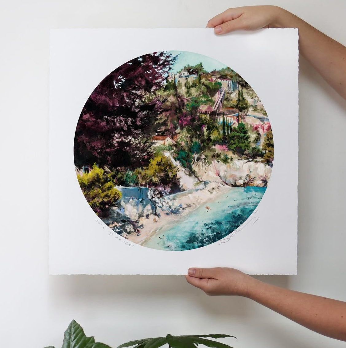 Dark foliage, light dunes, and vibrant water with swimmers. 