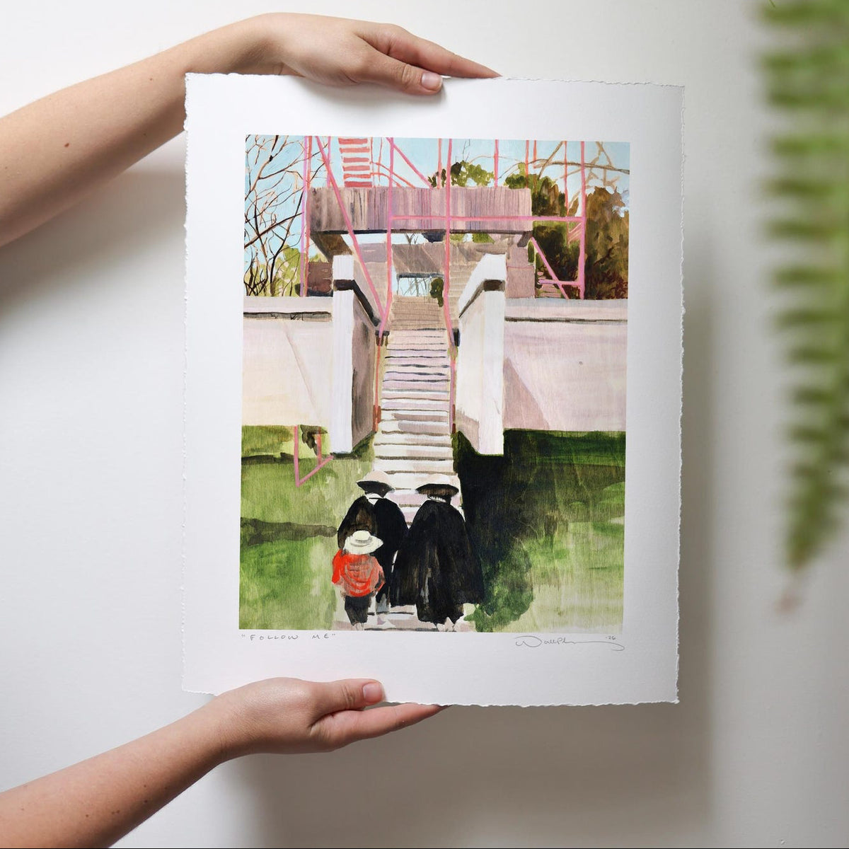 2 figures lead a small individual up the stairs of a modern building against green grass and bare tree branches. 