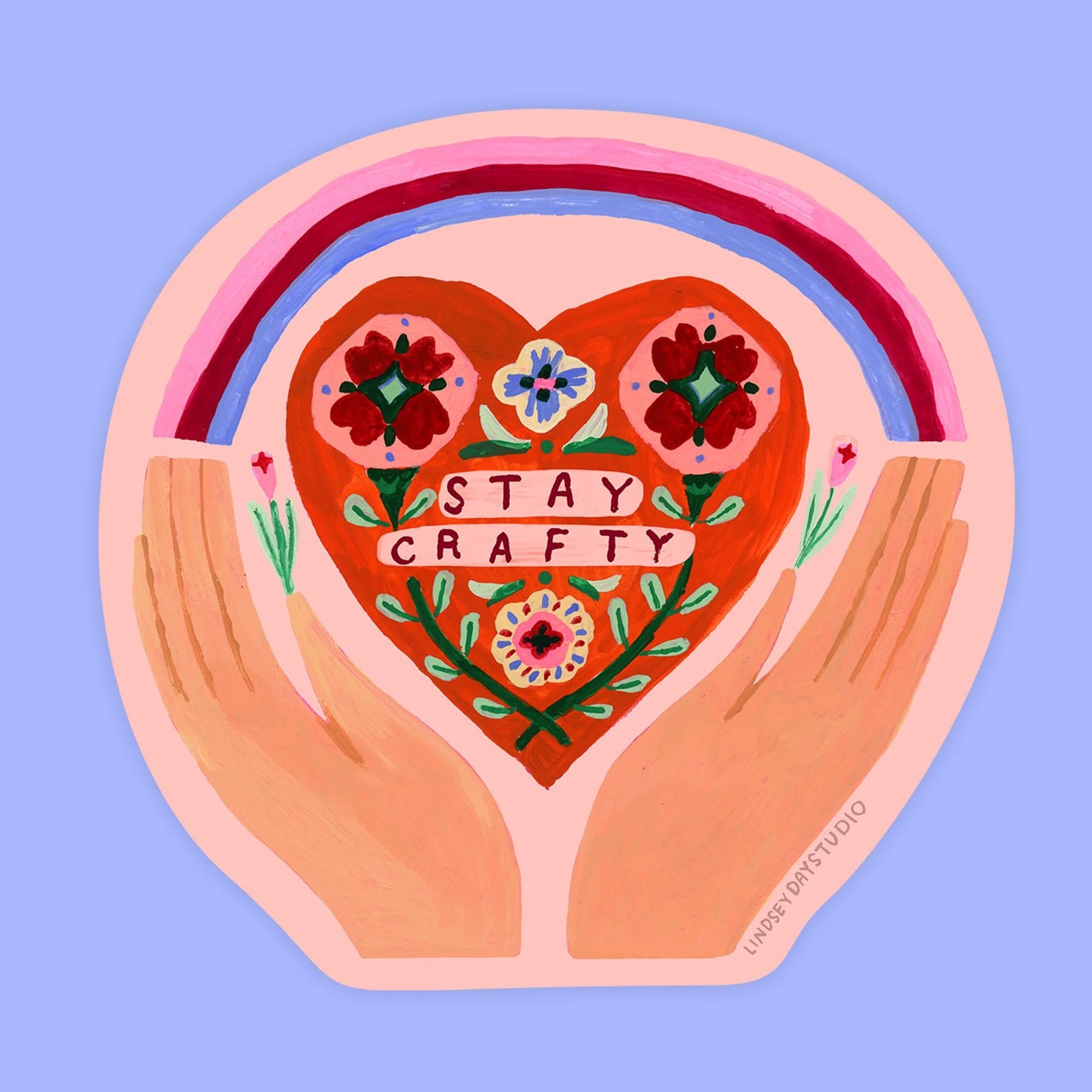 Hands cup a heart that says stay crafty with a rainbow spreading overtop. 