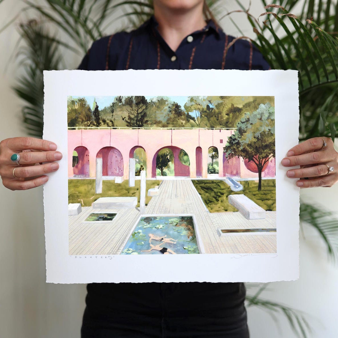 Pink archways stand over a tranquil lounge area centered around a lily pad pool with two floating individuals. 