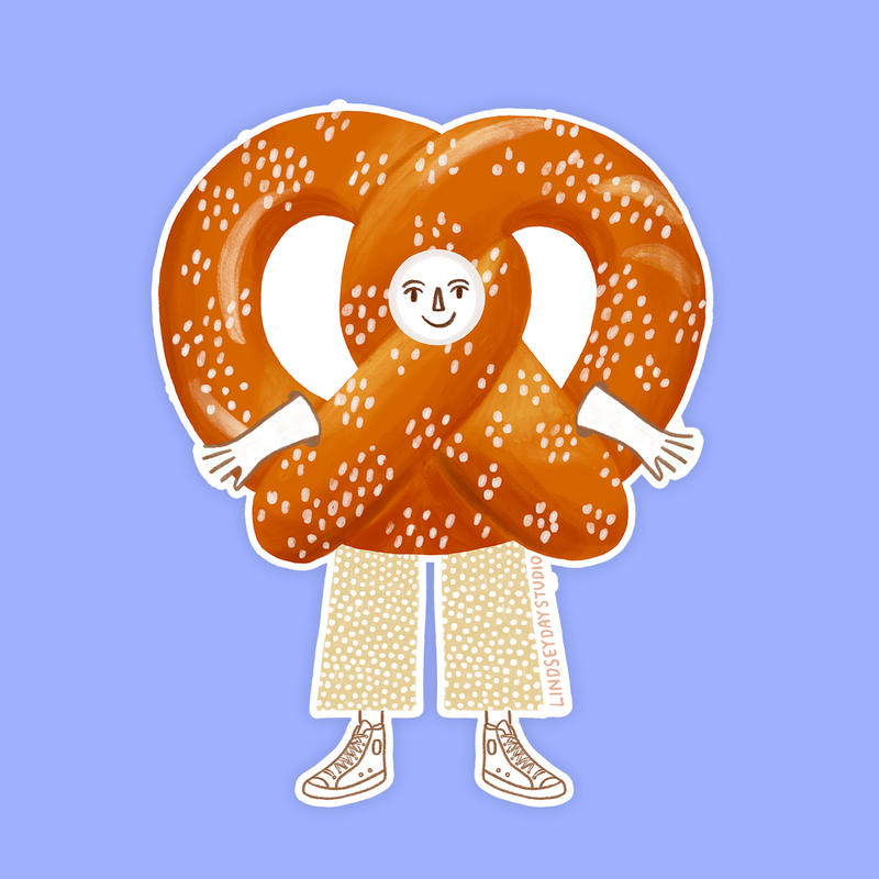 Brown pretzel with a face, arms and legs. 