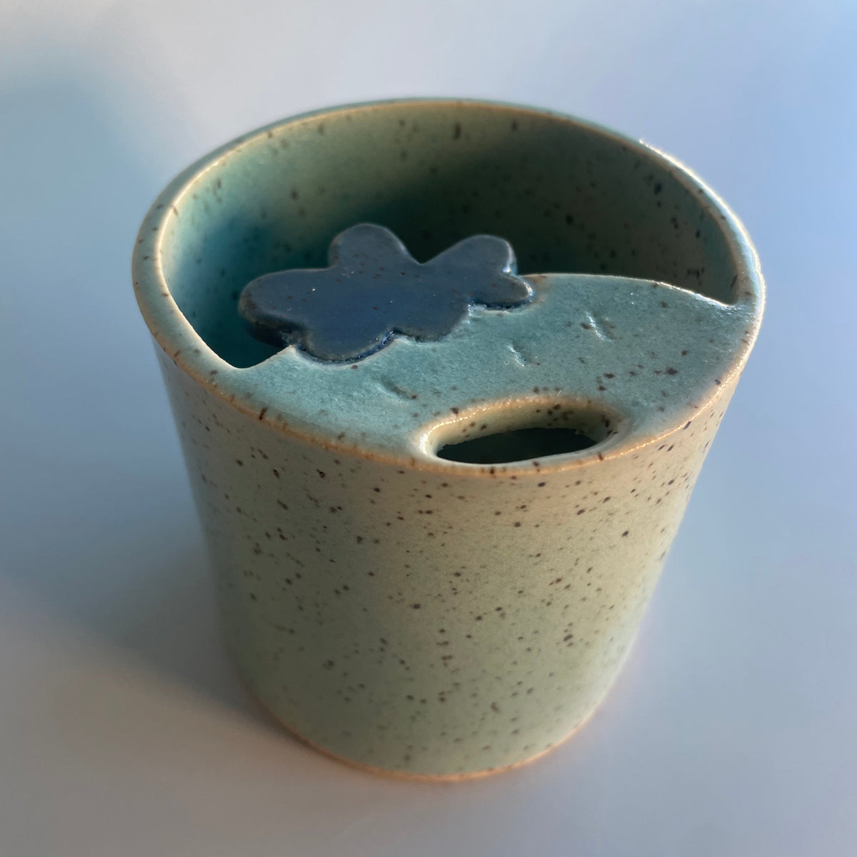 blue sipper travel cup with a blue strawberry at the top