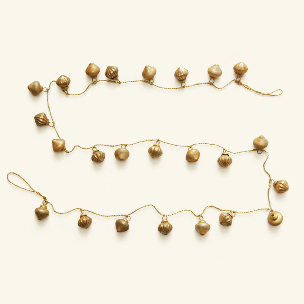 Gold decorative garland with small balls on a white background